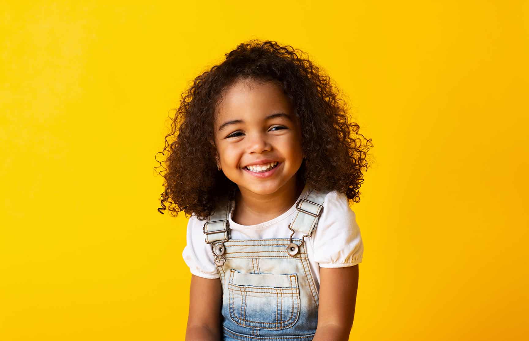 young girl smiling Honey Bee Pediatric Dentistry in Lawrence, KS