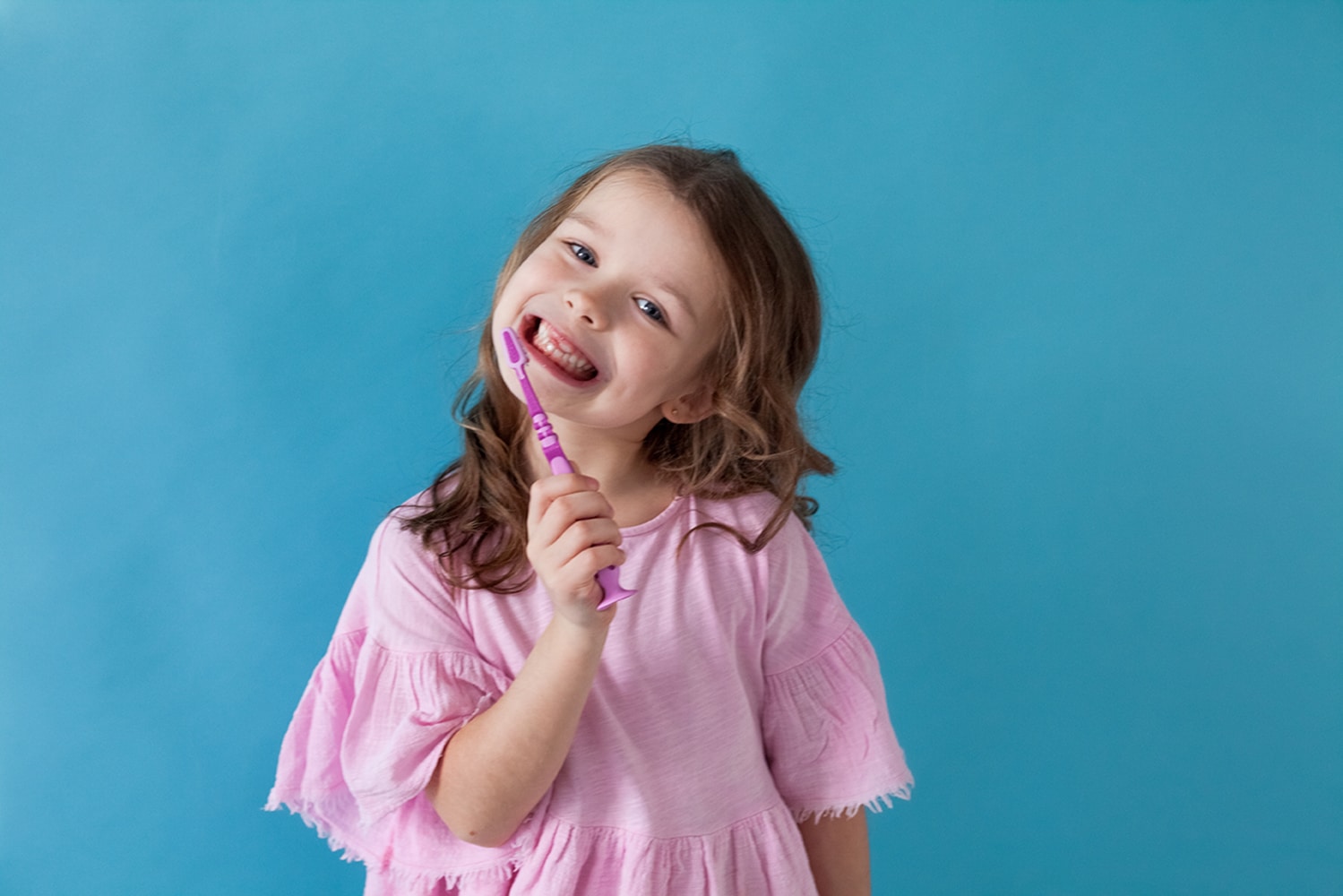 Girl smiling after a pediatric dental visit in Lawrence, KS, and Lenexa, KS.