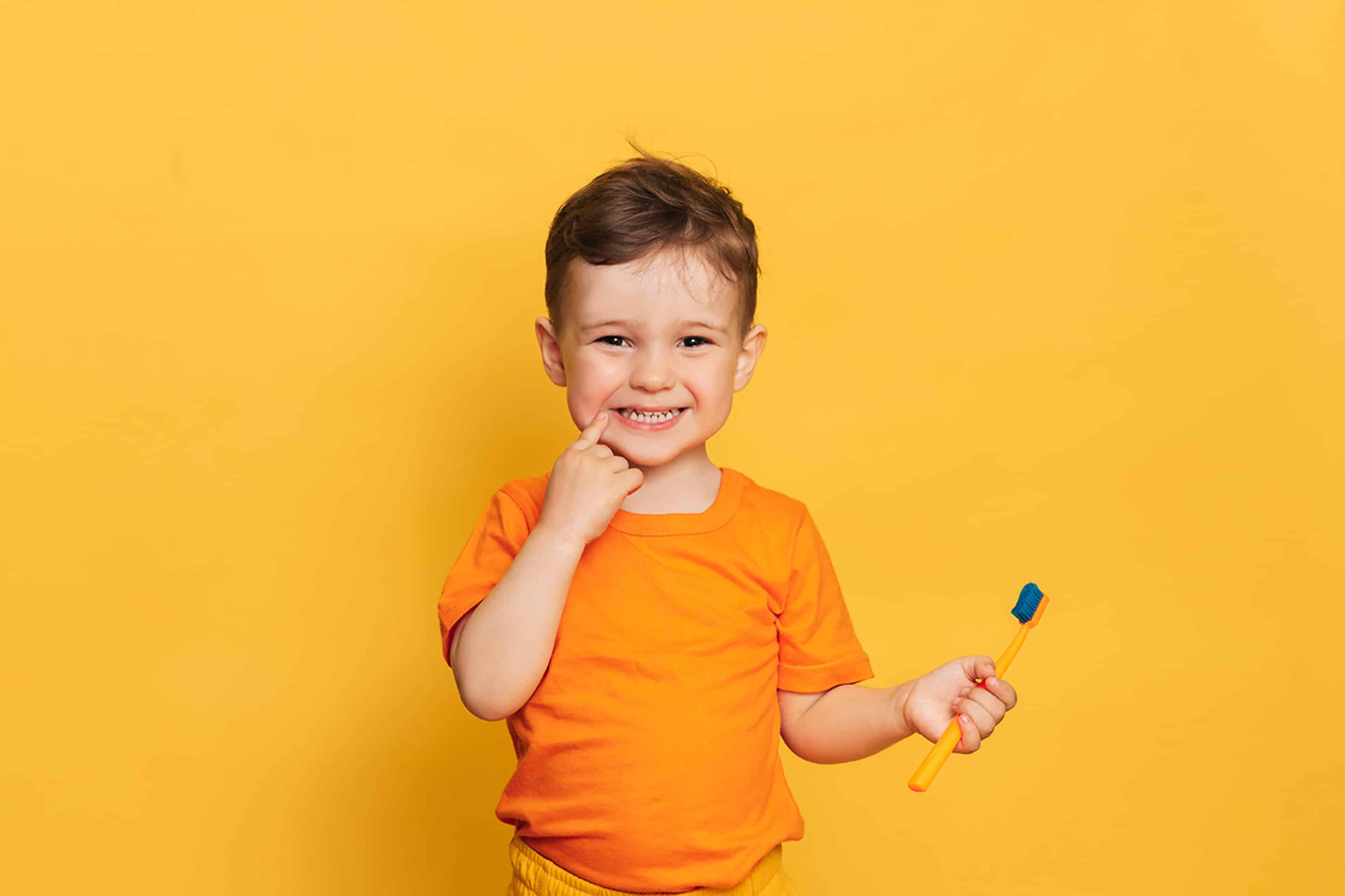 Young boy smiling after his dental evaluation in Lawrence, KS and Lenexa, KS