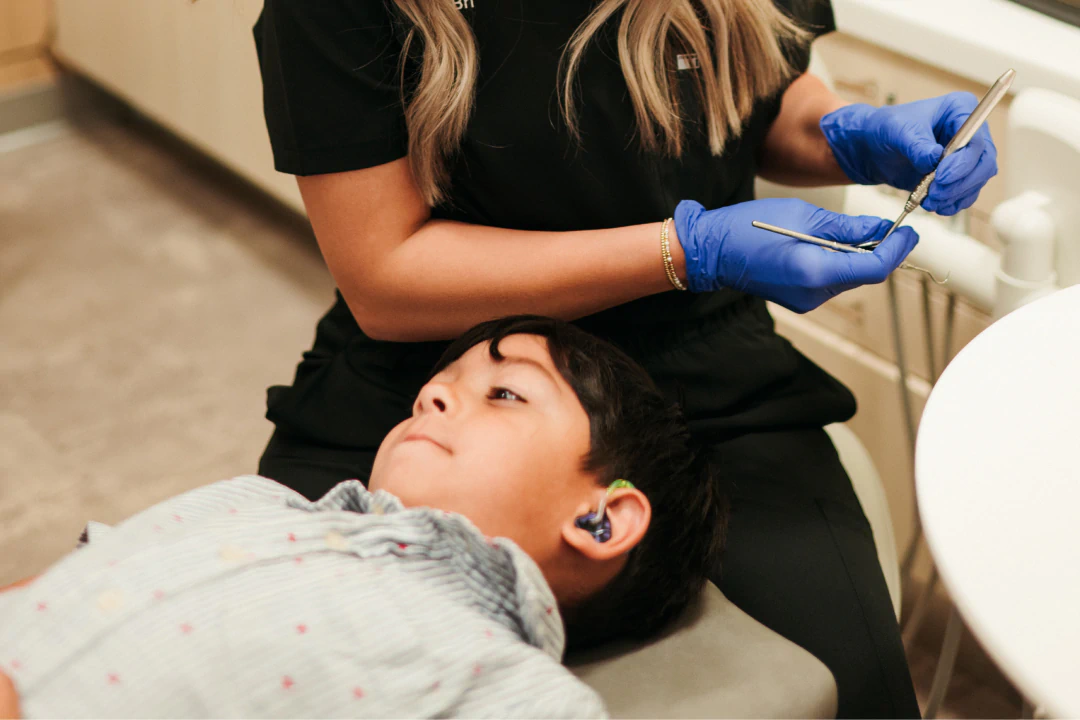 Children smiling after getting a tooth extraction near Lawrence, KS