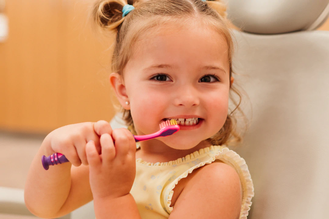 Girl smiling after a pediatric dental visit in Lawrence, KS, and Lenexa, KS.